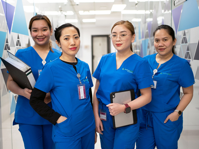 Group of healthcare professionals in scrubs.